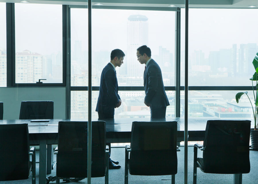Two Businessmen Bowing to Each Other