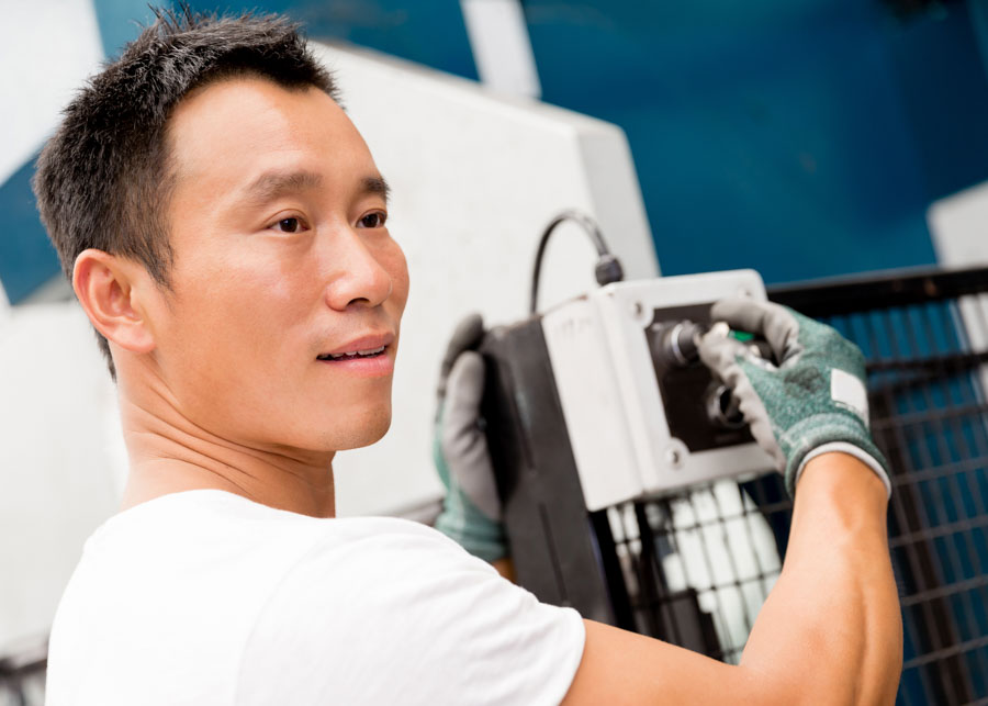 portrait of asian worker in production plant working on the factory floor