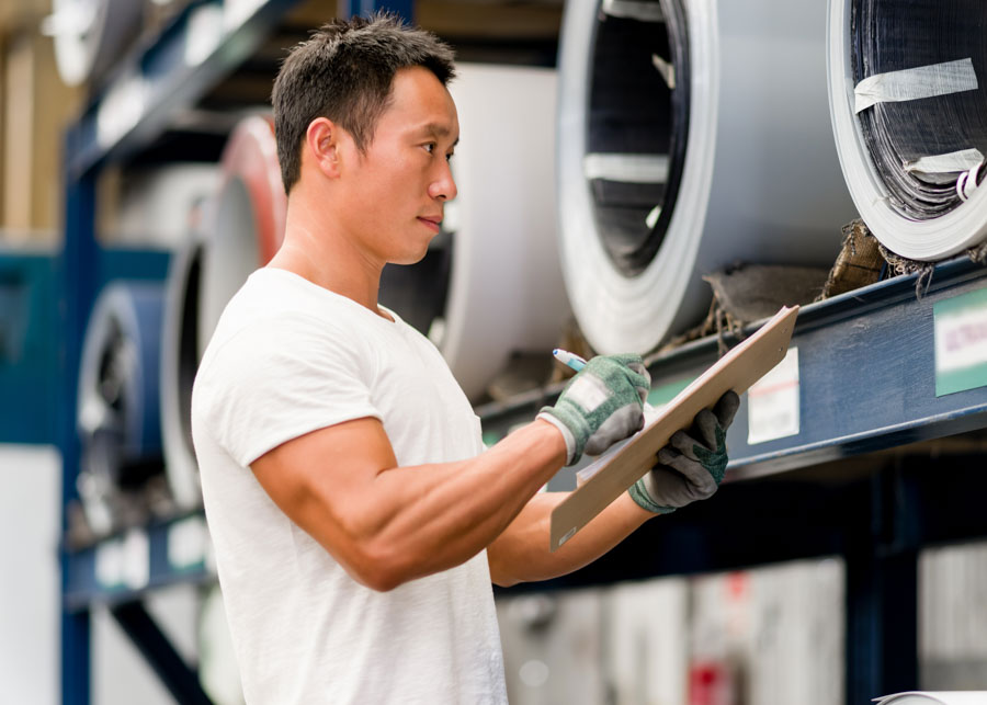portrait of asian worker in production plant working on the factory floor